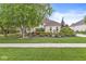 Charming brick home with a well-manicured lawn, mature trees, and vibrant flower beds showcasing curb appeal at 3655 Copperleaf Blvd, Greenwood, IN 46143