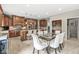 Open kitchen layout with stainless appliances, breakfast bar, custom cabinets, and nearby dining table at 3655 Copperleaf Blvd, Greenwood, IN 46143