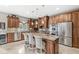 Gourmet kitchen with stainless steel appliances, custom cabinets, granite countertops, and large island at 3655 Copperleaf Blvd, Greenwood, IN 46143
