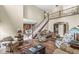 A welcoming living room with hardwood floors, area rug, and staircase leading to the second level at 3655 Copperleaf Blvd, Greenwood, IN 46143