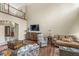 Spacious living room with hardwood floors, high ceilings, and a view of the foyer at 3655 Copperleaf Blvd, Greenwood, IN 46143