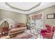 Cozy living room with hardwood floors, tray ceiling, comfortable seating, and a large window at 3655 Copperleaf Blvd, Greenwood, IN 46143
