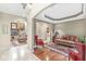 Elegant living room showcasing a fireplace, hardwood floors, and a view through an archway at 3655 Copperleaf Blvd, Greenwood, IN 46143