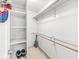 Clean walk-in closet with carpeted floors, wooden hanging racks, and shelving at 3655 Copperleaf Blvd, Greenwood, IN 46143