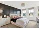 This spacious bedroom features black accent wall, a large bed, and two windows offering neighborhood views at 3671 Pinnacle Dr, Bargersville, IN 46106