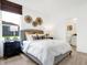 Bright bedroom with a large window, modern decor, and a neutral color palette provides a calm and relaxing atmosphere at 3671 Pinnacle Dr, Bargersville, IN 46106