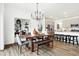 Dining room featuring a wooden table, modern chandelier, and convenient access to the kitchen at 3671 Pinnacle Dr, Bargersville, IN 46106