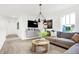 Inviting living room featuring a gray sectional, modern lighting, and a view of the neighborhood at 3671 Pinnacle Dr, Bargersville, IN 46106