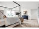 Open main bedroom featuring a four-poster bed, sitting area, and modern dresser, creating a luxurious and relaxing space at 3671 Pinnacle Dr, Bargersville, IN 46106