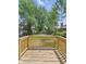 Backyard with a wooden deck and greenery, perfect for outdoor relaxation at 401 Harlan St, Indianapolis, IN 46201