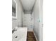 Bathroom featuring a sink vanity and a standalone shower with white tiled walls at 401 Harlan St, Indianapolis, IN 46201
