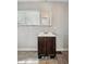 A basic bathroom with a vanity, a window with blinds, and a mirror at 401 Harlan St, Indianapolis, IN 46201