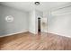 Empty bedroom with hardwood floors, a window, and a closet door to another room at 401 Harlan St, Indianapolis, IN 46201