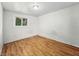 Well-lit bedroom with hardwood floors and a bright window at 401 Harlan St, Indianapolis, IN 46201