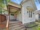 Charming home featuring a quaint front porch and the house number over the door at 401 Harlan St, Indianapolis, IN 46201