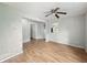 Living room with hardwood floors, a ceiling fan, and access to other rooms at 401 Harlan St, Indianapolis, IN 46201