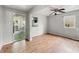Open living room with hardwood floors, a ceiling fan, and ample natural light at 401 Harlan St, Indianapolis, IN 46201