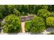 An aerial view of the property showcasing landscaping, mature trees, and layout at 445 W 63Rd St, Indianapolis, IN 46260