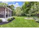 Serene backyard offering a screened-in porch, manicured lawn, and a fire pit area at 445 W 63Rd St, Indianapolis, IN 46260