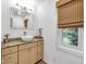 Powder room features a modern vessel sink, granite countertops, decorative mirror, and natural light from a window at 445 W 63Rd St, Indianapolis, IN 46260