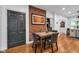 Breakfast nook features exposed brick wall and door to hall at 445 W 63Rd St, Indianapolis, IN 46260