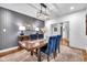 Elegant dining room featuring blue velvet chairs, a wooden table, and stylish wallpaper at 445 W 63Rd St, Indianapolis, IN 46260