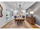 Elegant dining room with stylish wallpaper, a wooden table with blue chairs, and ample natural light at 445 W 63Rd St, Indianapolis, IN 46260