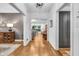 Inviting foyer with hardwood floors, decorative wallpaper, and a glimpse into the open living spaces at 445 W 63Rd St, Indianapolis, IN 46260