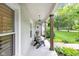 Inviting front porch showcasing comfortable chairs and views of the beautifully landscaped yard at 445 W 63Rd St, Indianapolis, IN 46260