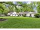 Spacious front yard with mature landscaping, features a well-maintained lawn and inviting facade at 445 W 63Rd St, Indianapolis, IN 46260