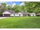 Well-maintained home with large front yard, mature trees, and a spacious two-car garage at 445 W 63Rd St, Indianapolis, IN 46260