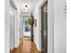 Hallway with hardwood floors, neutral walls, and an open view to the exterior, creating a bright and inviting entrance at 445 W 63Rd St, Indianapolis, IN 46260