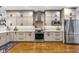 Bright kitchen featuring stainless steel appliances, ample cabinet space, and hardwood floors at 445 W 63Rd St, Indianapolis, IN 46260