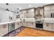 Renovated kitchen showcasing stainless steel appliances, stylish countertops, and hardwood flooring at 445 W 63Rd St, Indianapolis, IN 46260