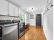 Well-equipped laundry room features modern washer and dryer units, bright cabinetry, and stylish shiplap walls at 445 W 63Rd St, Indianapolis, IN 46260