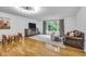Bright living room boasts hardwood floors, a large window, and neutral decor, creating a welcoming space at 445 W 63Rd St, Indianapolis, IN 46260