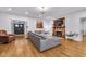 Bright living area showcases hardwood floors, a fireplace, and large sectional sofa for relaxation at 445 W 63Rd St, Indianapolis, IN 46260