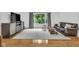 Bright living room features a large window, a plush rug, and hardwood floors at 445 W 63Rd St, Indianapolis, IN 46260