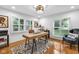 Bright home office with a wooden desk, zebra rug, hardwood floors and natural light from windows with shutters at 445 W 63Rd St, Indianapolis, IN 46260