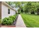 Inviting walkway lined with decorative plants leading to a charming single-story home at 445 W 63Rd St, Indianapolis, IN 46260