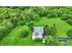 Aerial view of house with pool and a large lawn surrounded by trees and green space at 4495 W Stones Crossing Rd, Greenwood, IN 46143