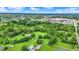 Aerial view of a lush green community with a home with pool, mature trees, pond, and verdant surroundings at 4495 W Stones Crossing Rd, Greenwood, IN 46143