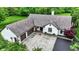 Aerial view of the white home with an attached garage and a large driveway with a gray shingled roof at 4495 W Stones Crossing Rd, Greenwood, IN 46143