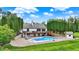 Scenic view of a backyard with a sparkling pool, wooden deck, storage shed, and a beautiful house at 4495 W Stones Crossing Rd, Greenwood, IN 46143
