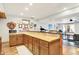 Open concept wet bar featuring wood floors, butcher block countertops, wood cabinets, and decor on the wall at 4495 W Stones Crossing Rd, Greenwood, IN 46143