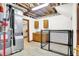 Basement utility room featuring a furnace, cabinets, sink and a tiled floor with a cage at 4495 W Stones Crossing Rd, Greenwood, IN 46143
