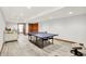 Finished basement featuring a table tennis table and tile floors, with access to another room at 4495 W Stones Crossing Rd, Greenwood, IN 46143