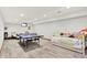 Finished basement featuring a ping pong table, daybed and tile floors at 4495 W Stones Crossing Rd, Greenwood, IN 46143