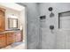 Bathroom with walk in shower and wood cabinets with granite countertops at 4495 W Stones Crossing Rd, Greenwood, IN 46143