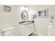 Stylish bathroom with granite countertop, oval mirror, and a modern framed artwork at 4495 W Stones Crossing Rd, Greenwood, IN 46143